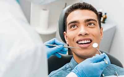 a man having his teeth cleaned at the dental office