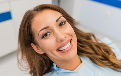 Woman smiling after wearing Invisalign in Forest Park